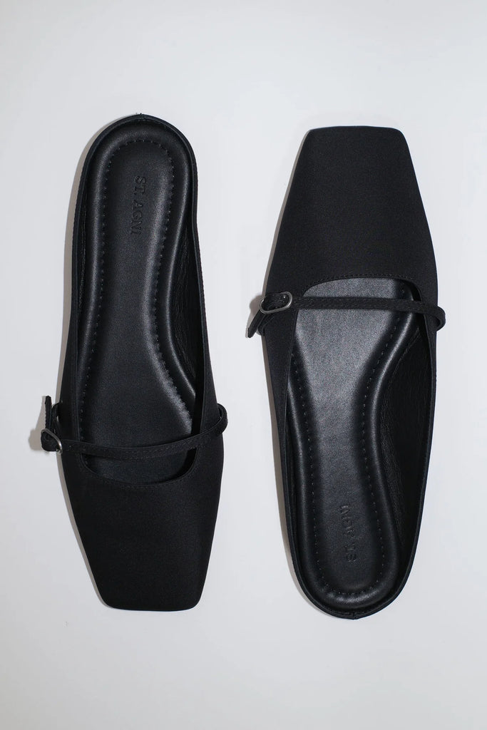 Pair of black loafers on a white background