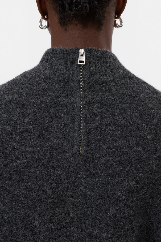 Dark gray zip-up sweater with a white background