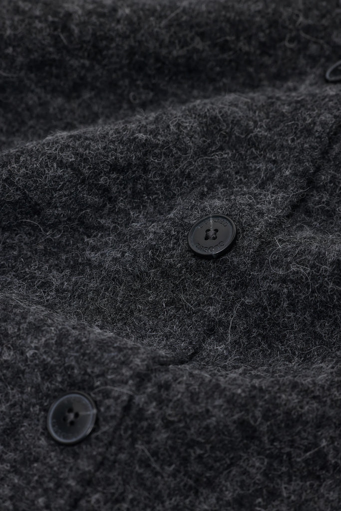 Close-up of a dark gray textured fabric with buttons
