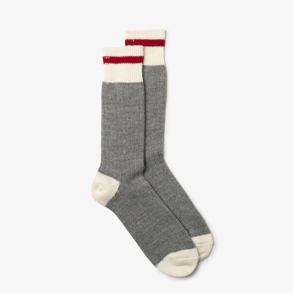 Gray knee-high socks with white and red accents on a white background