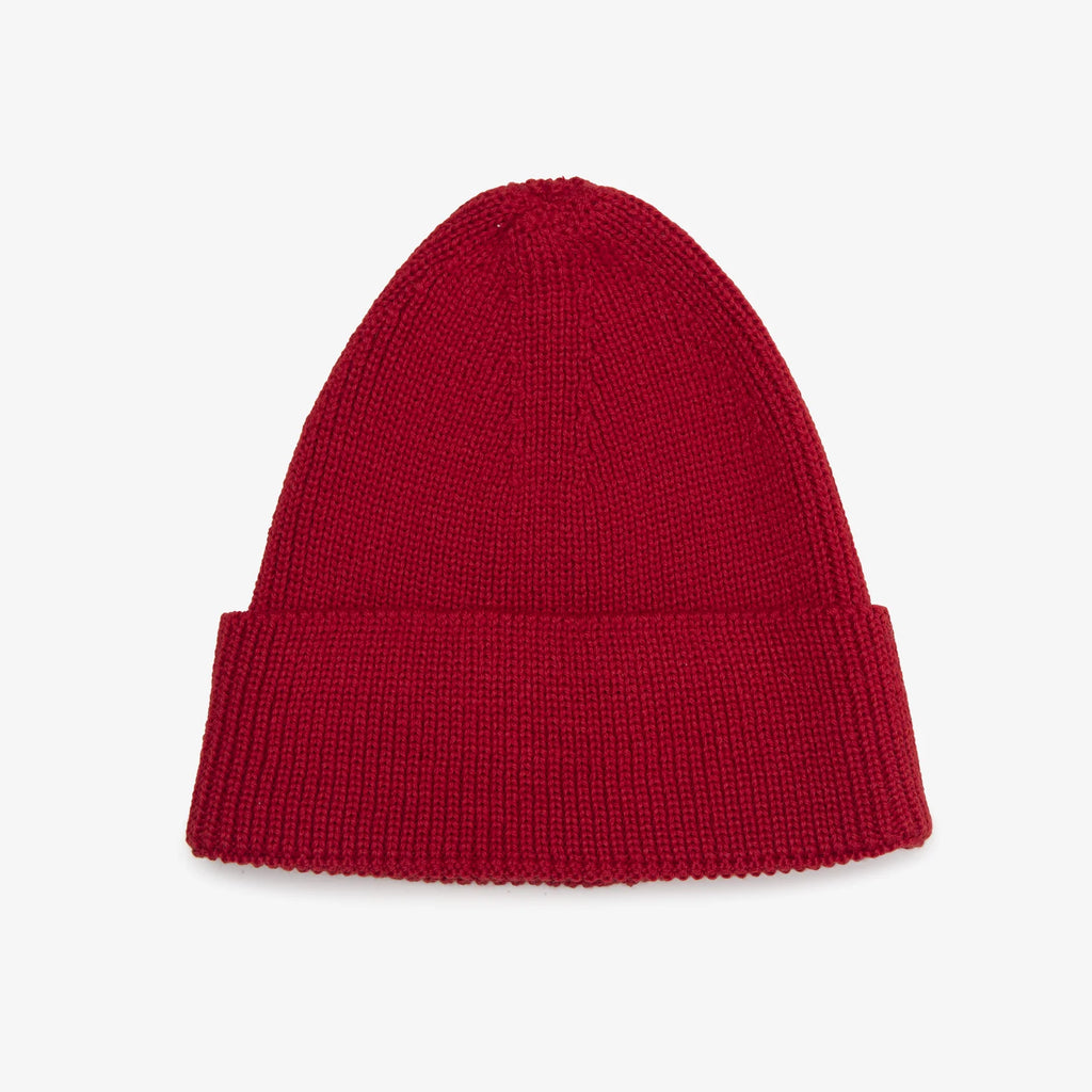 Red knit beanie on a light gray background