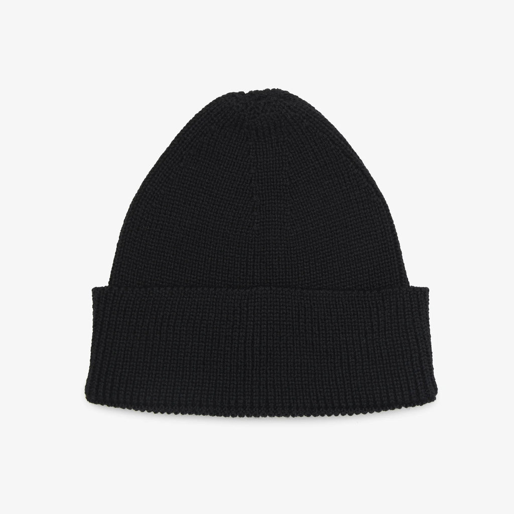 Black knit beanie on a light gray background