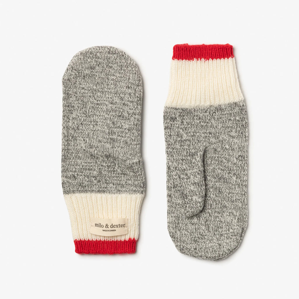 Pair of gray mittens with red and white accents on a light gray background