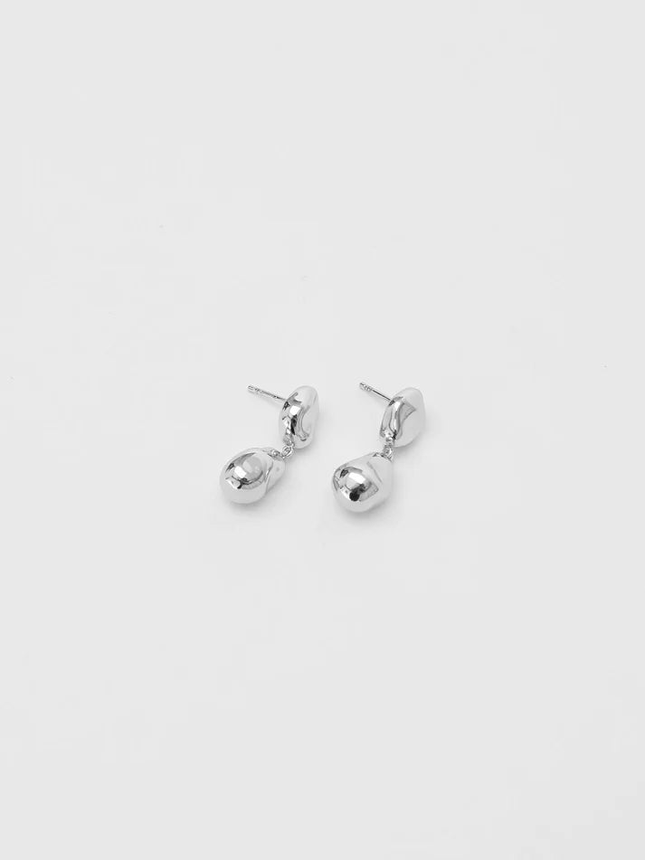Pair of silver earrings on a light gray background