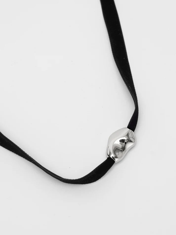 Black ribbon necklace with a silver clasp on a white background